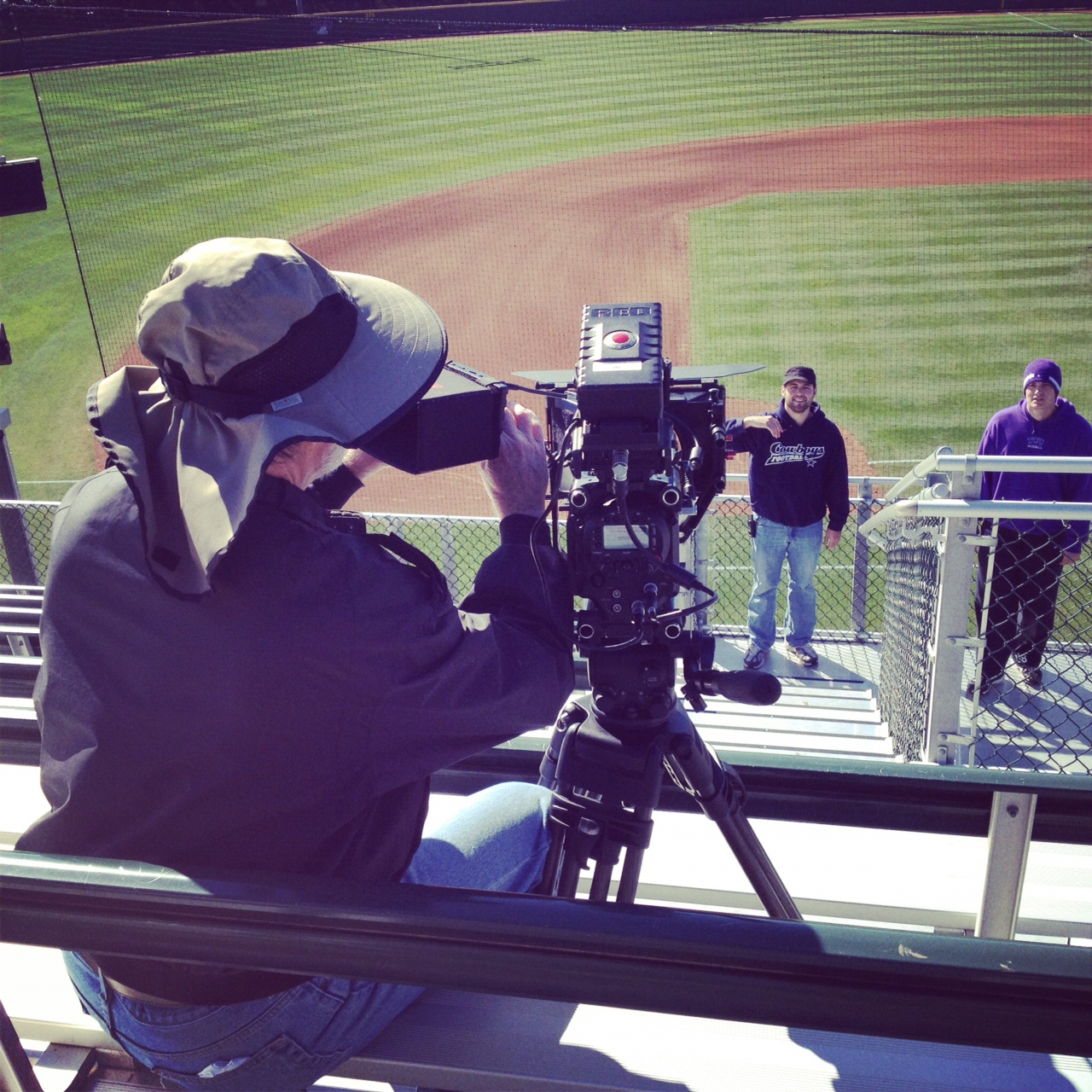 Picture of a Red Productions videographer filming during their professional Fort Worth video production for TCU Baseball entitled, "The Grind"